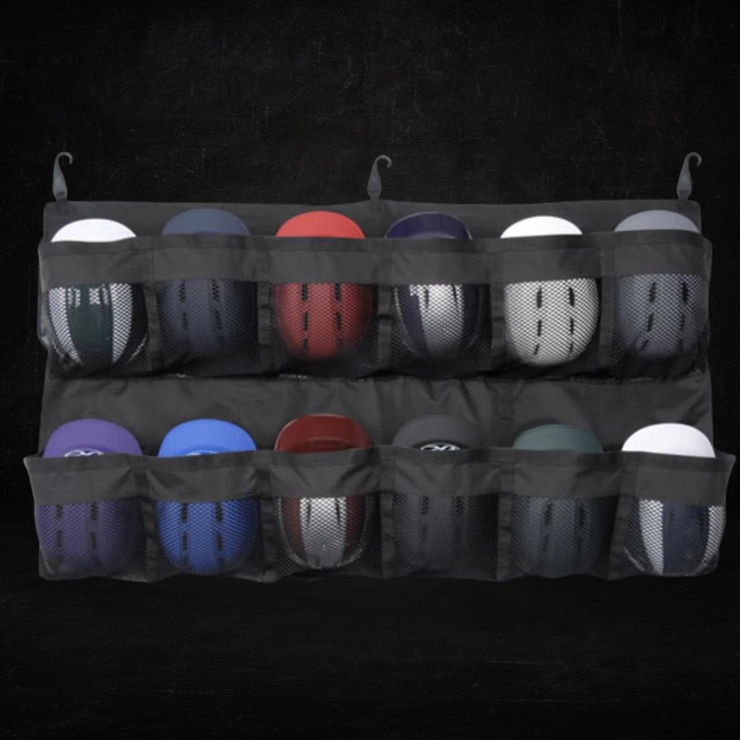 A wall-mounted storage organiser displaying various sports balls in black mesh compartments, including basketballs, footballs, and volleyballs in different colours.
