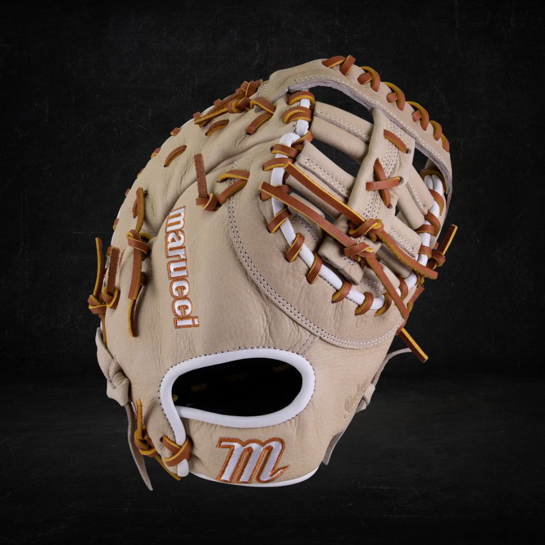A beige leather baseball glove with brown lacing and a prominent "M" logo branded on the thumb. Marucci